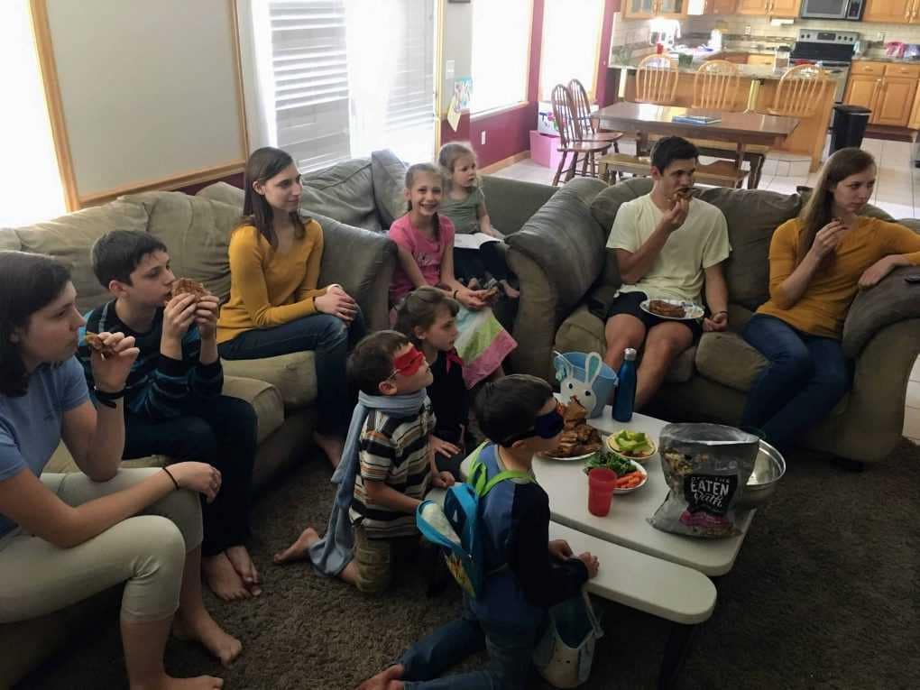 10 siblings watching a movie on the couch together