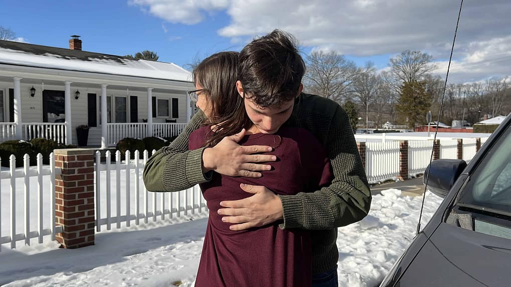 mom hugging son goodbye