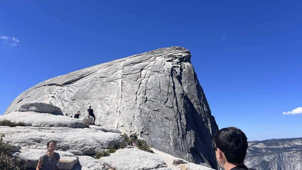people climbing the cables on half dome