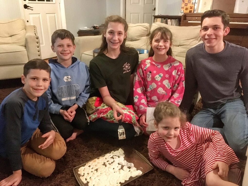 6 kids celebrating D. Todd Christofferson's birthday with brownies.