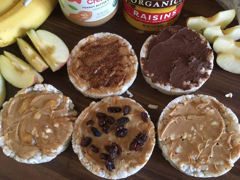 5 rice cakes with different toppings sitting on table