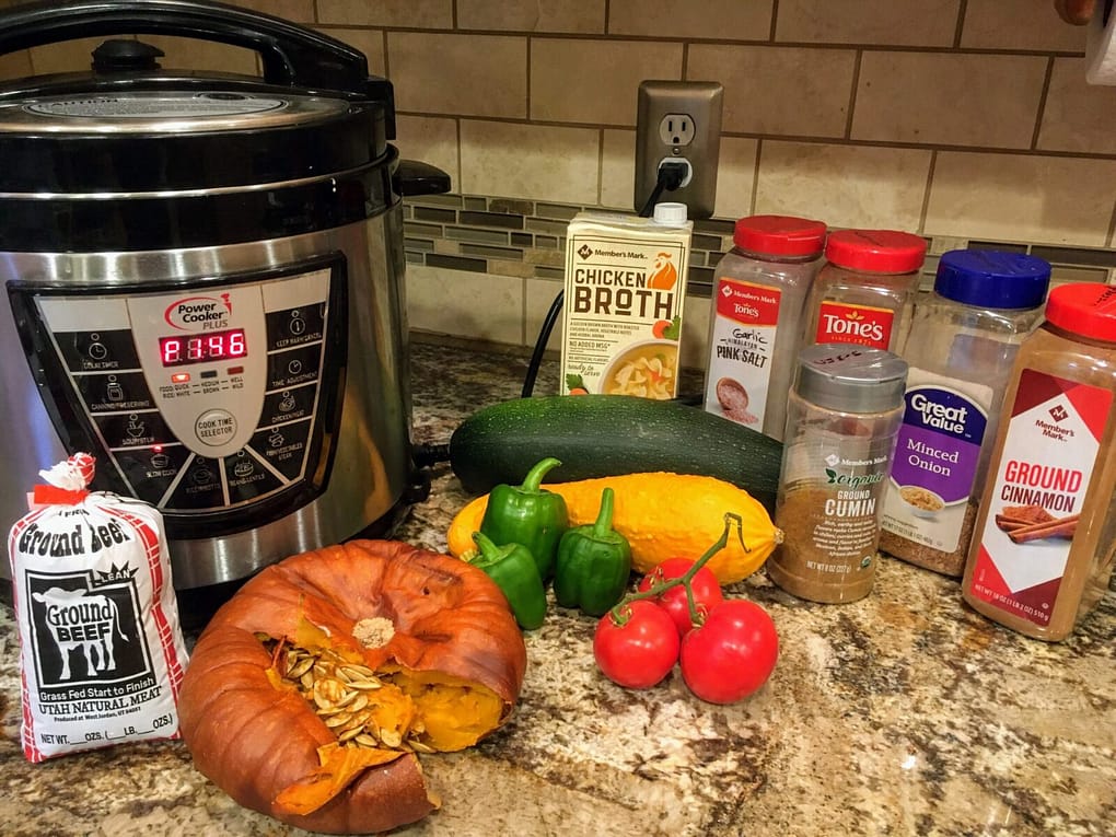 pumpkin chili ingredients on the counter in front of a crock pot