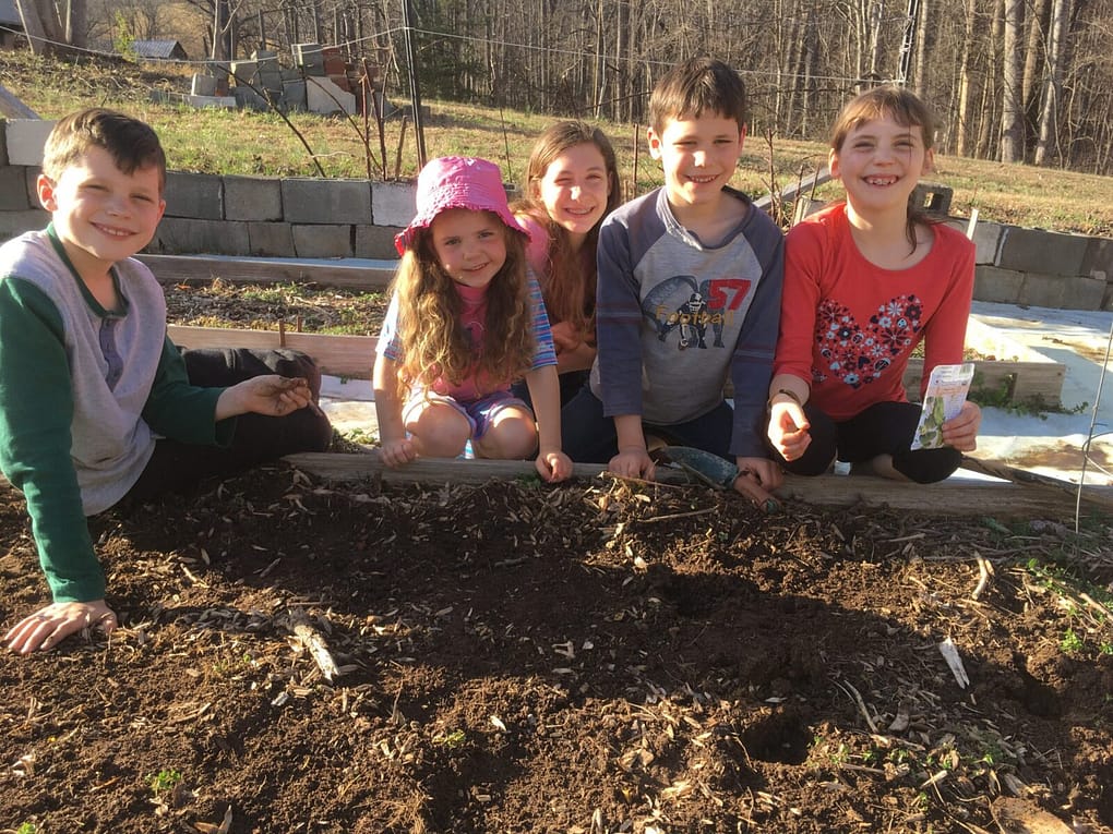 5 kids planting peas