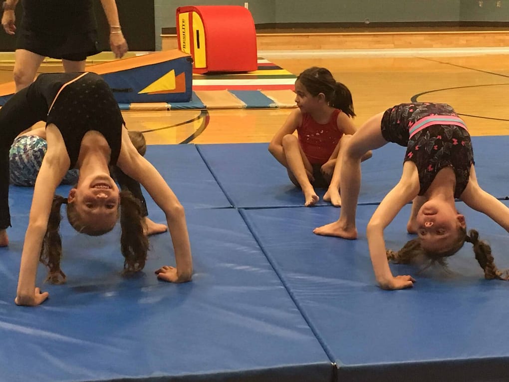 kids doing bridges in gymnastics class