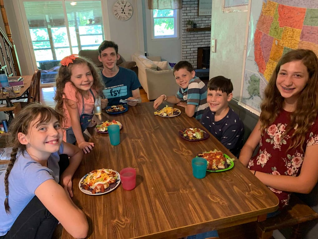 family eating cobb salad around the table