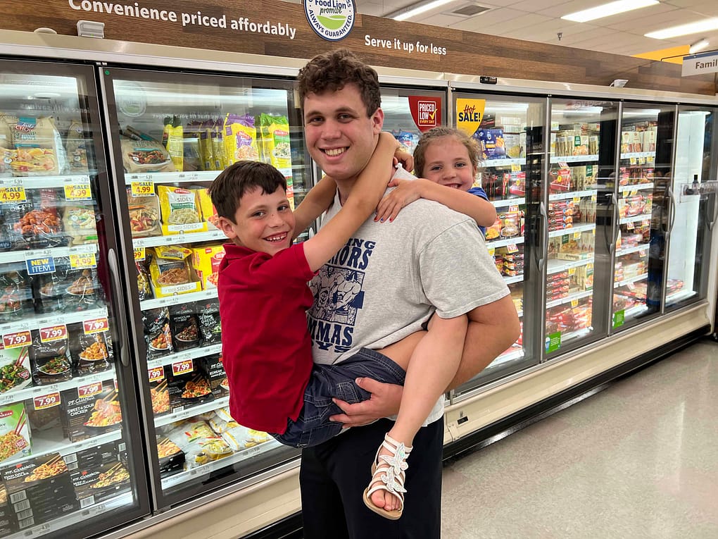 20 year old brother with a brother on his front and a sister on his back