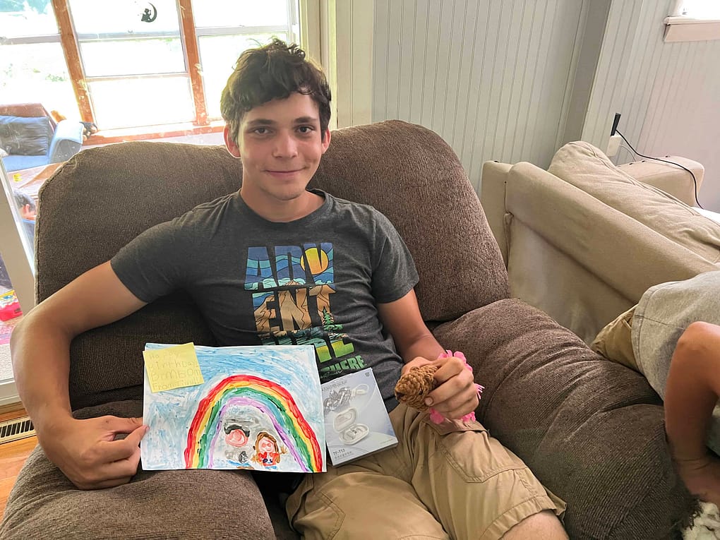 17 year old showing the presents he got for his birthday including a picture painted by his younger sister