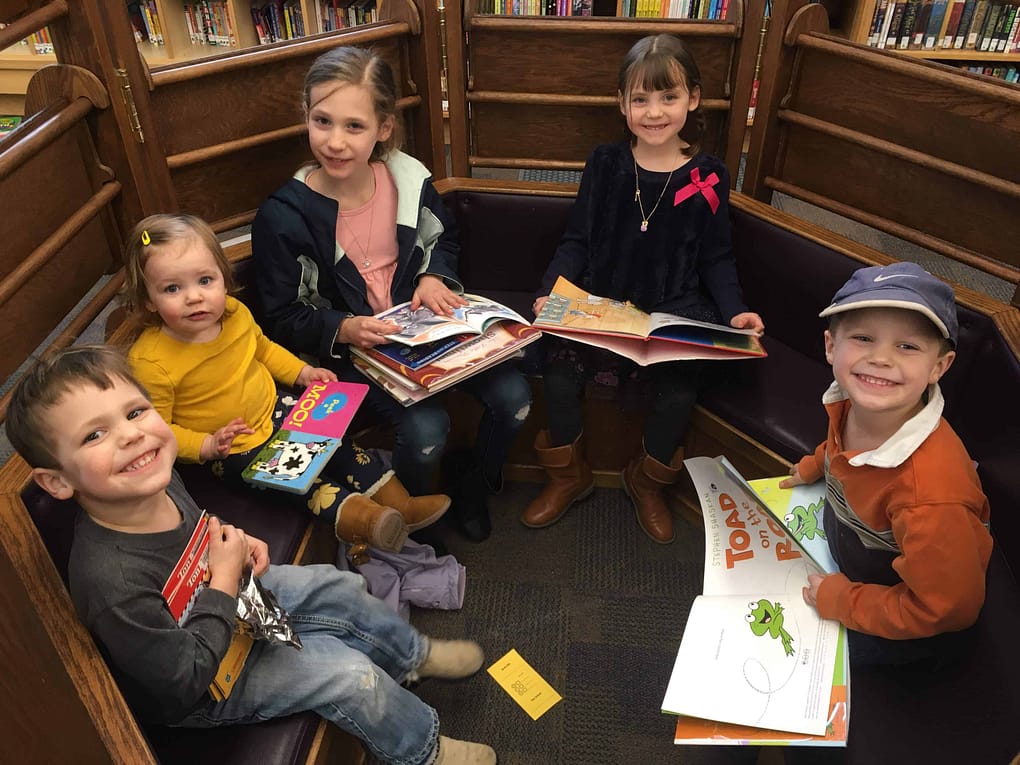 5 kids reading at the library