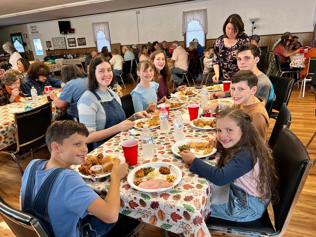 family eating at a potluck supper