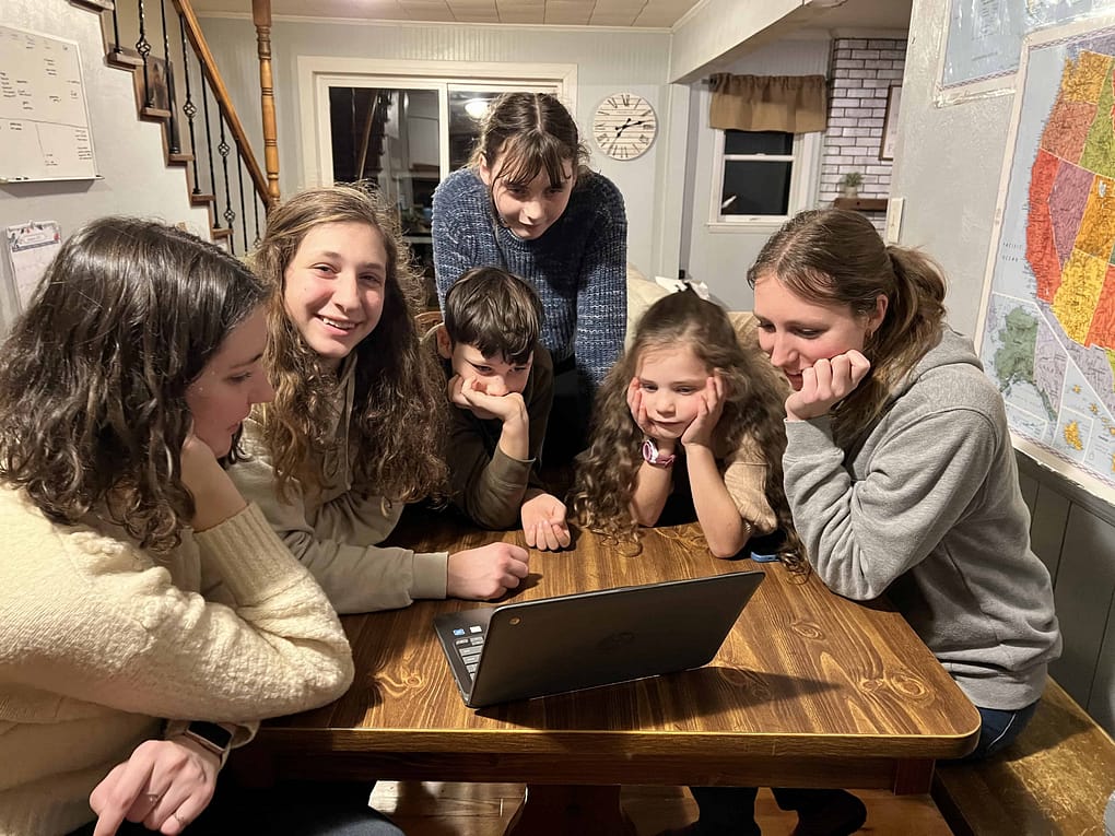 family watching home movies on a computer