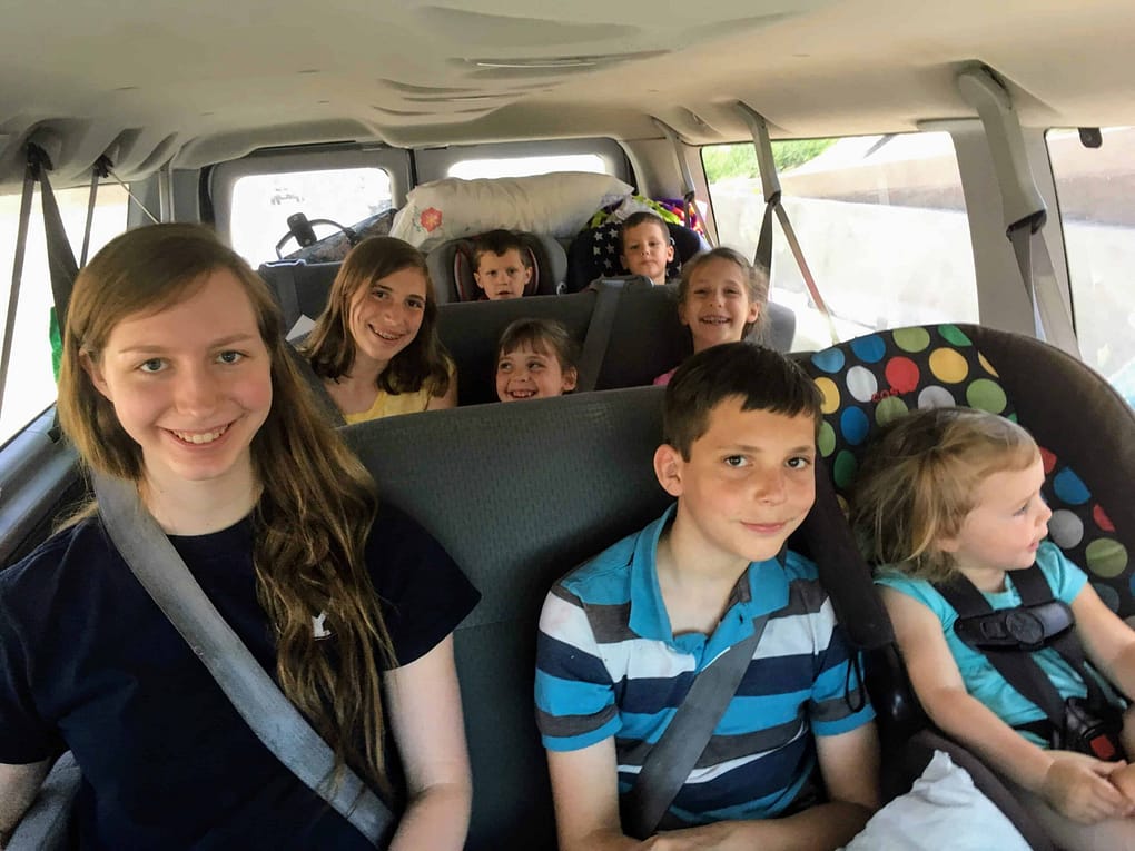 12 passenger van filled with siblings on a trip