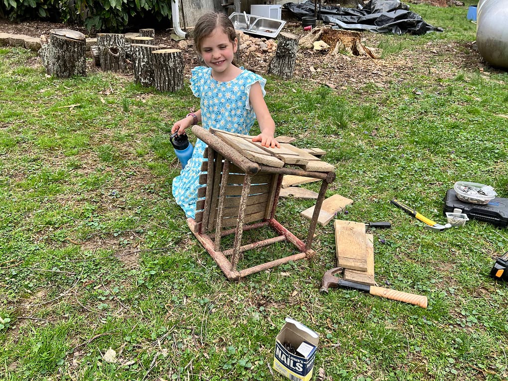 girl making a planter from old chair