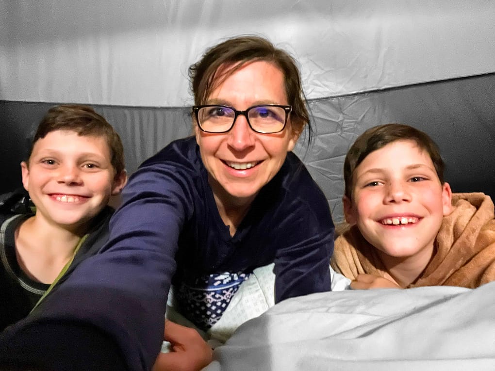 selfie of mom and 2 boys sleeping in tent