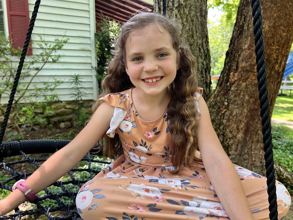 7 year old girl on a spiderweb swing