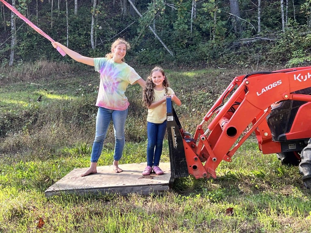 two siblings on a forklift