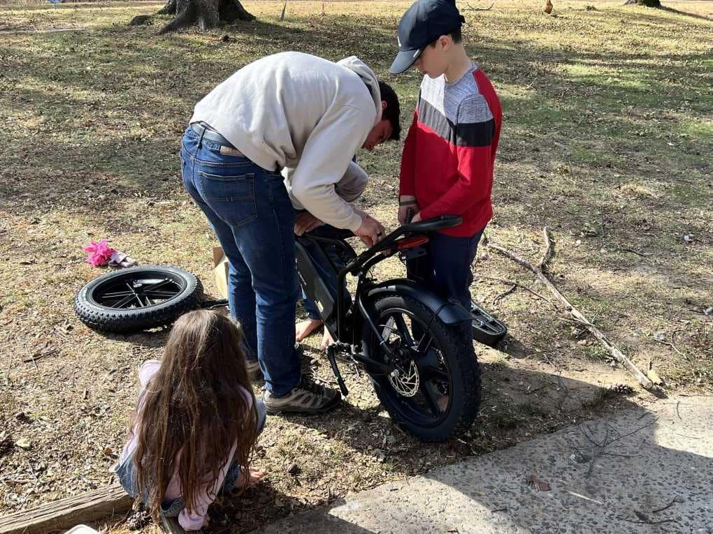 boys putting together ebike
