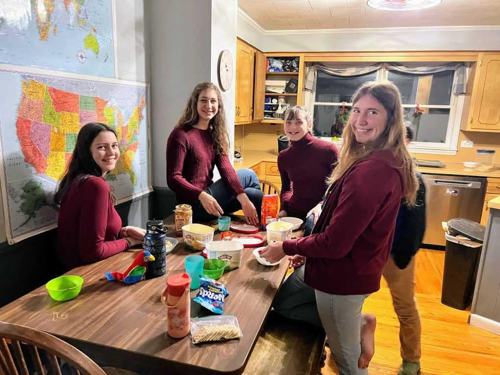sisters dishing up ice cream at the table