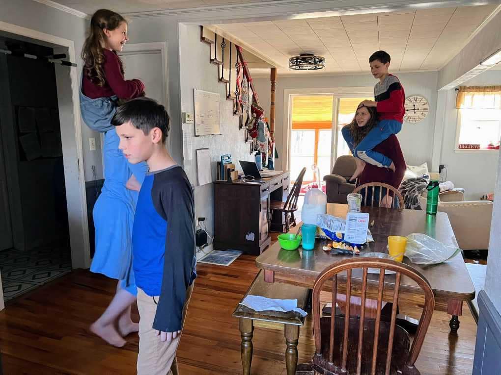 kids on shoulder rides in the dining room