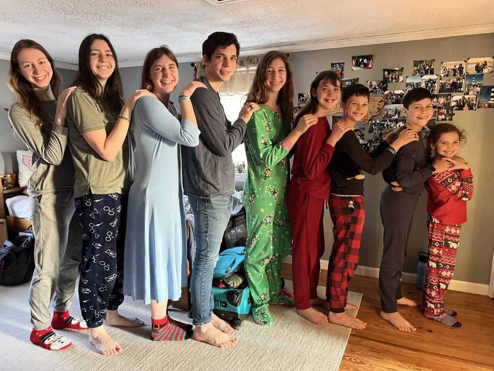 9 children lined up in age order on Christmas morning