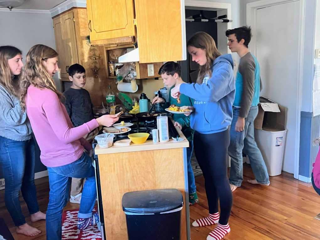 siblings making lunch at the counter