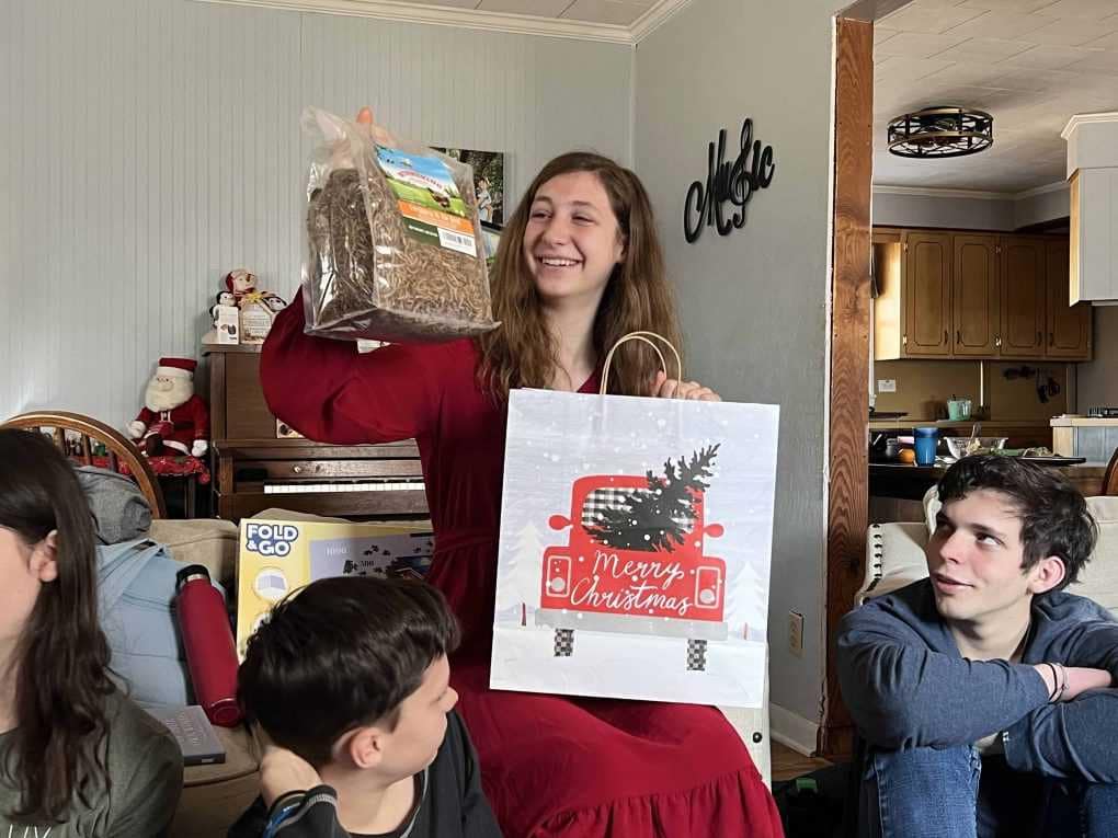 teen girl opening a bag of meal worms for a present