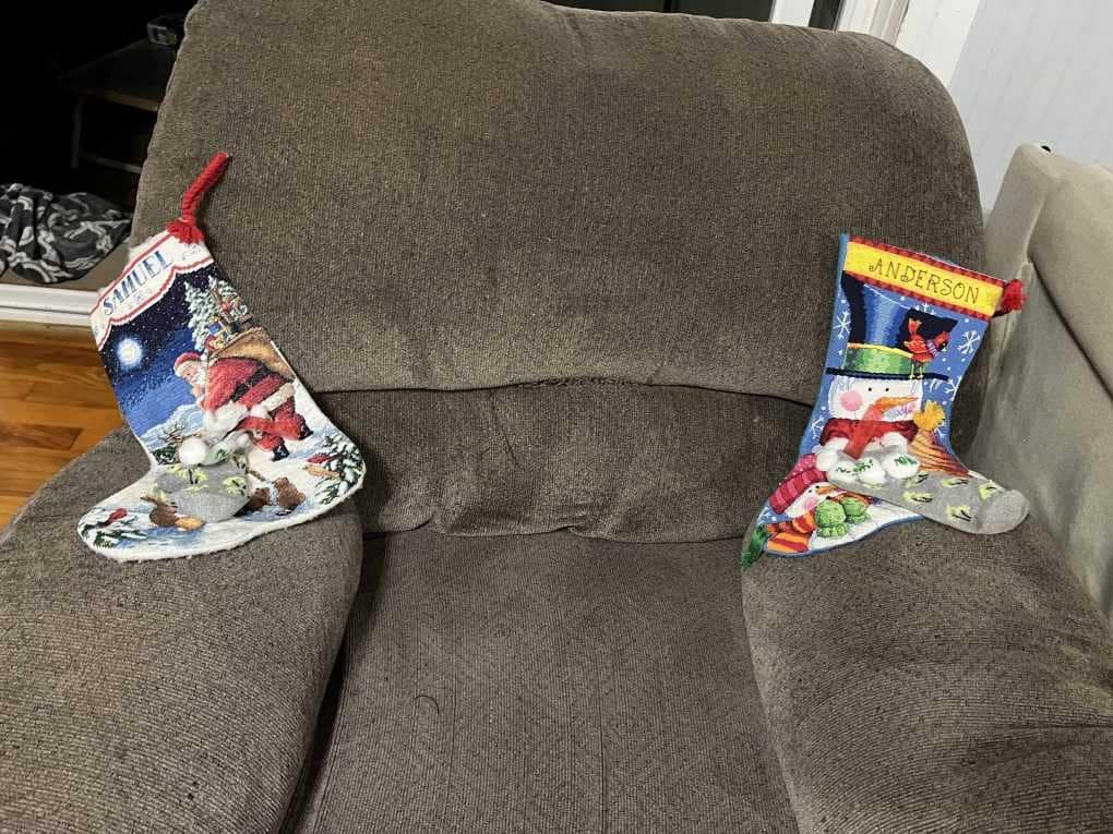 2 stockings on a couch waiting for Santa