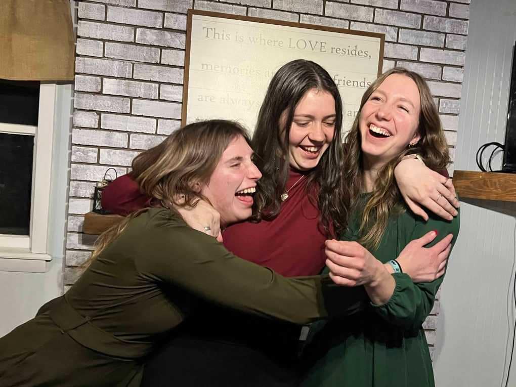 3 college sisters hugging