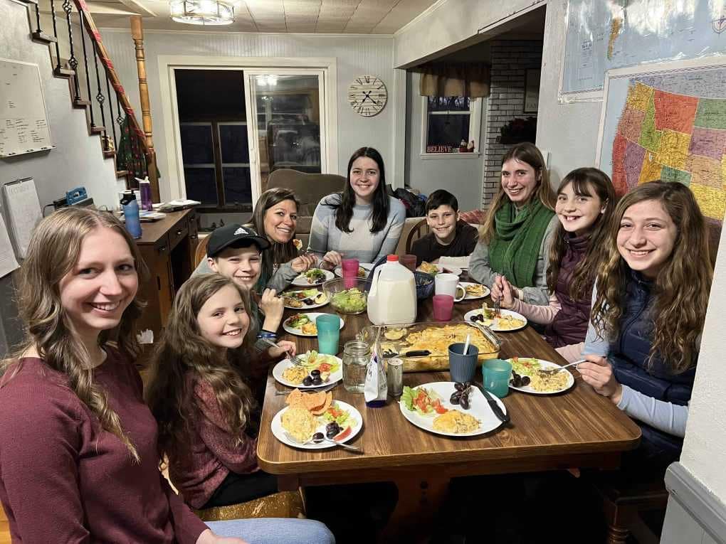 9 kids eating dinner around the table