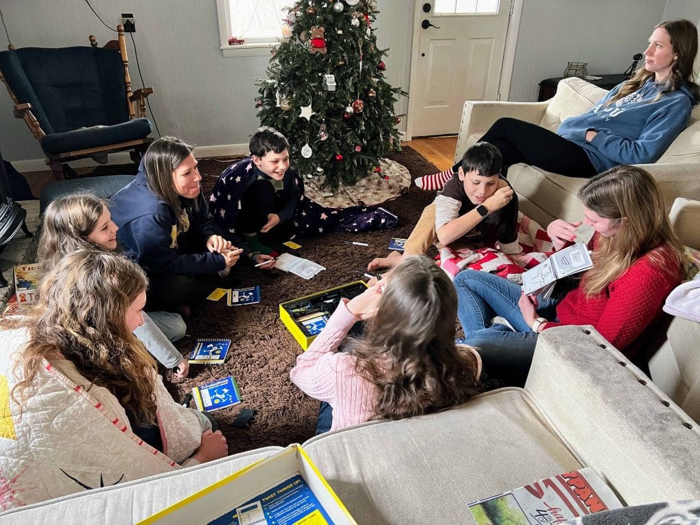 kids playing games by the Christmas tree