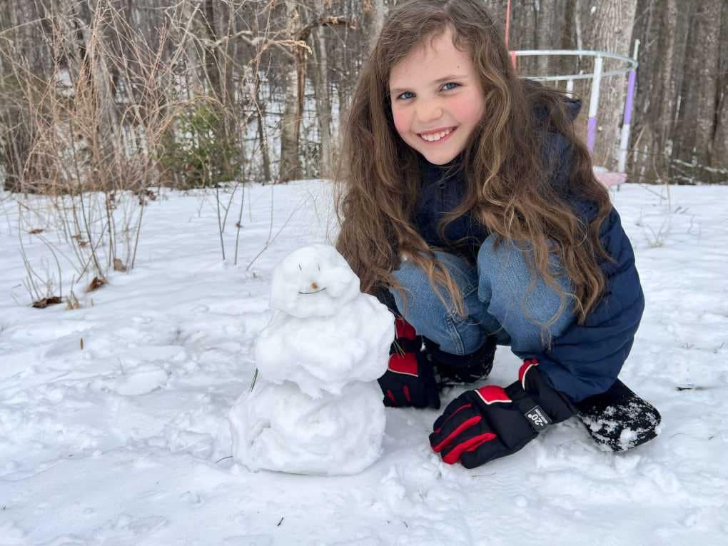 8 year old girl with snowman