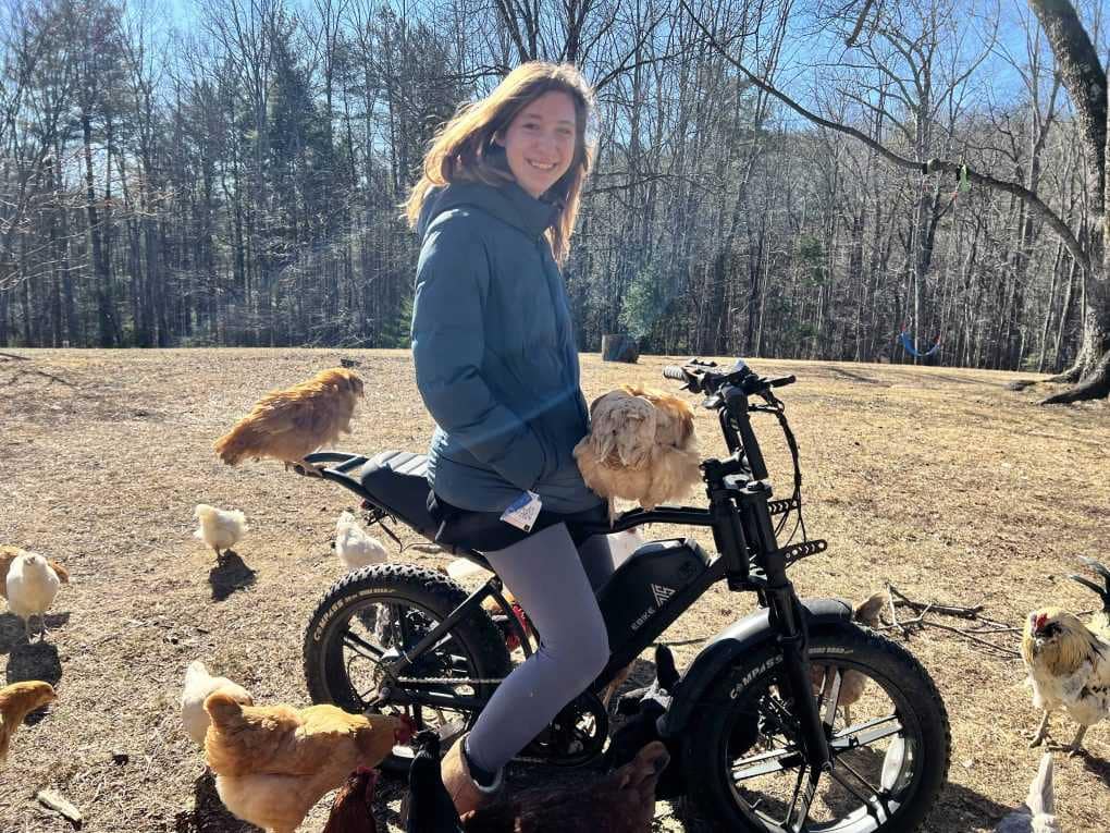 girl and chickens on e-bike