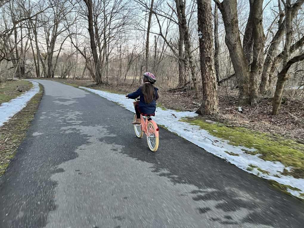 riding bike on paved trail