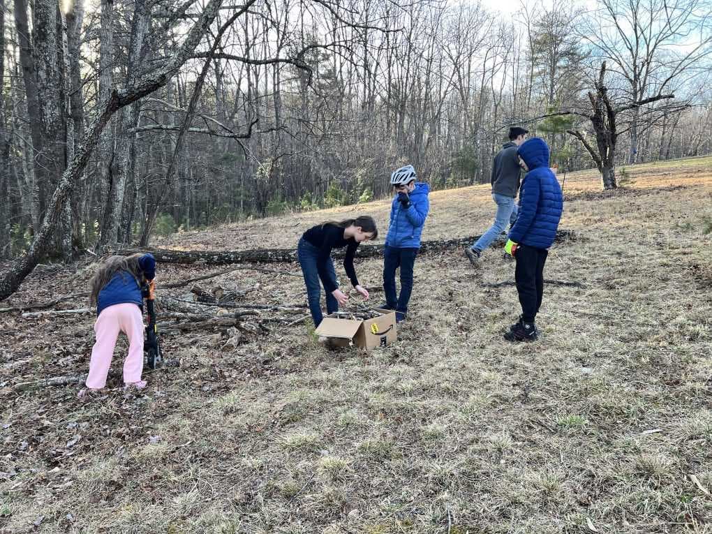kids cutting and hauling firewood
