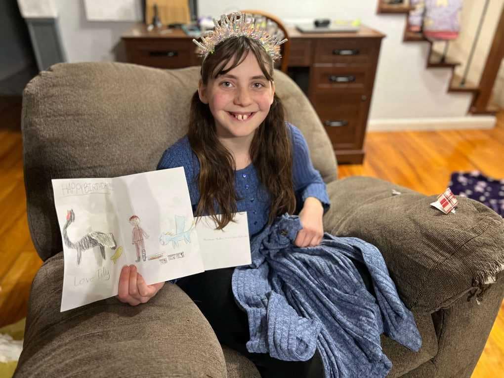 14 year old holding homemade birthday card