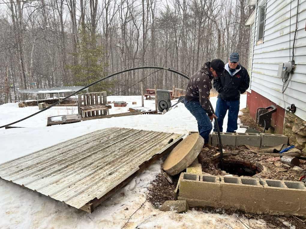 guys pulling out old well pump