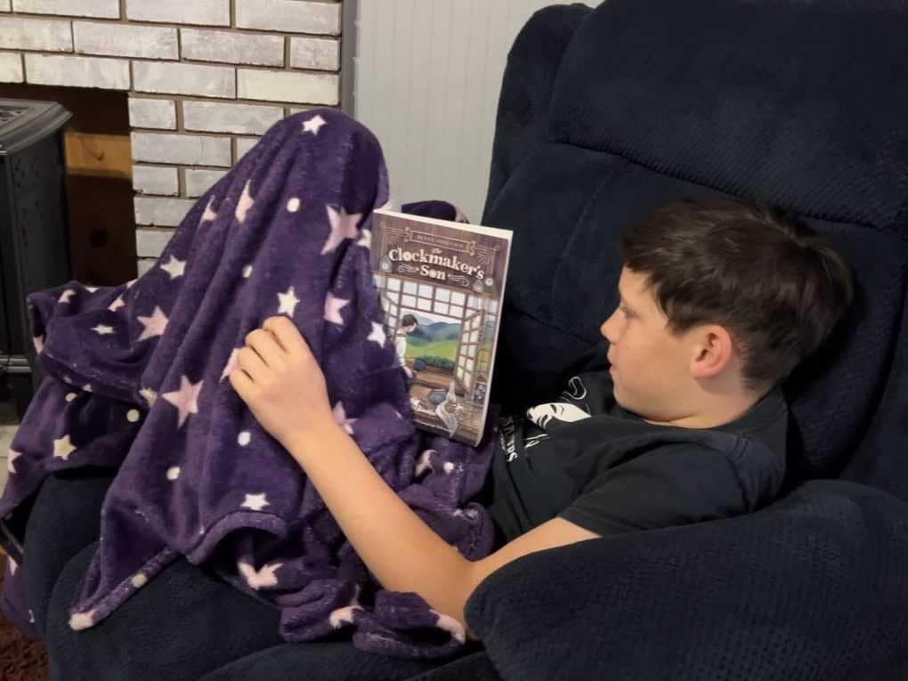 boy reading on armchair