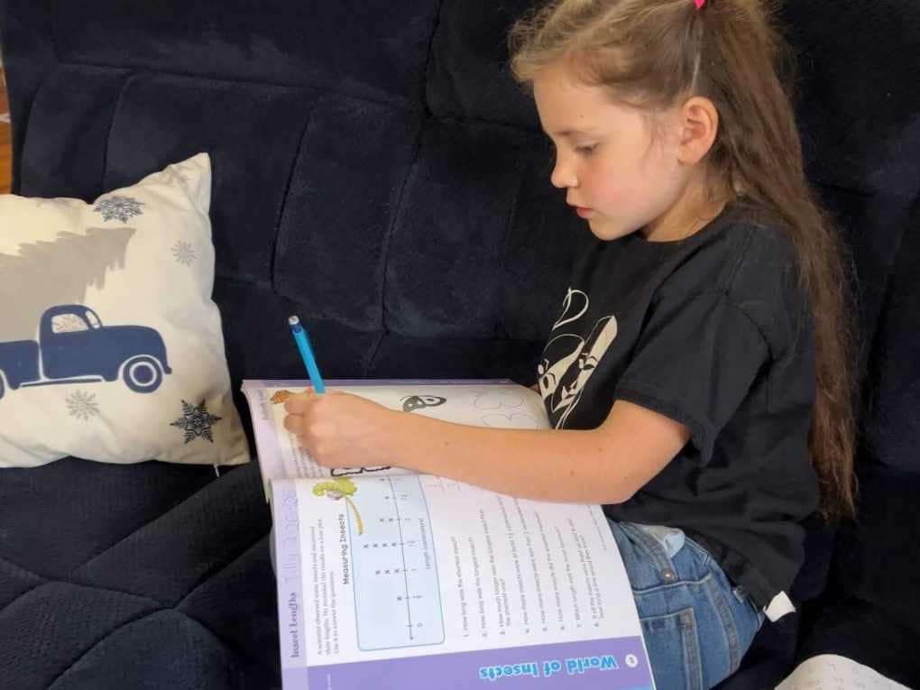 girl doing a school workbook