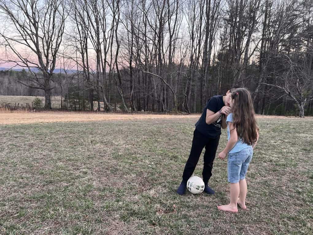 boy whispering plan in girl's ear