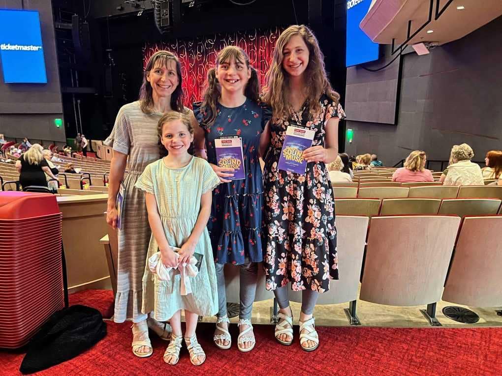 mom and daughters at a theater