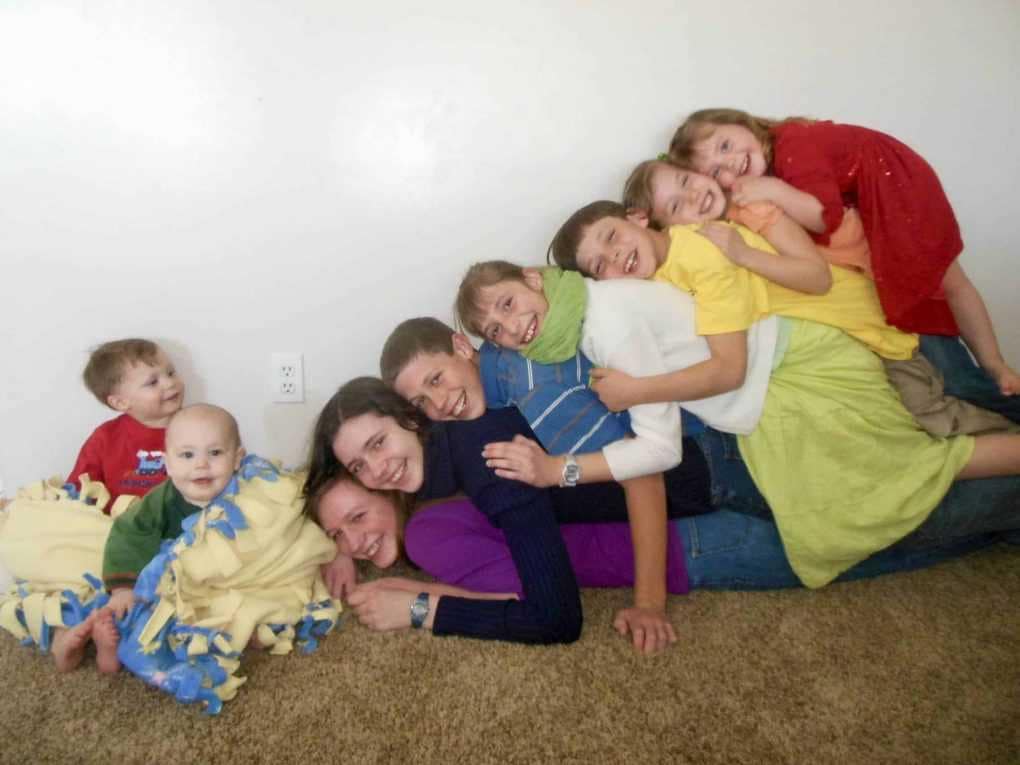 9 children stacked up like a rainbow.