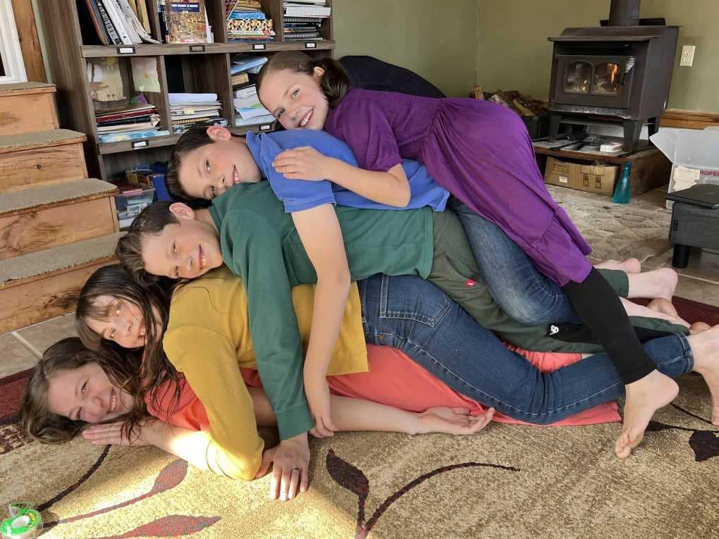 5 children stacked up looking like a rainbow