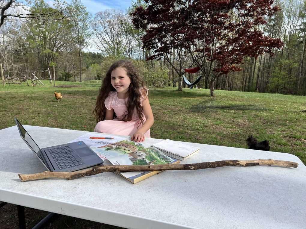 girl drawing at picnic table