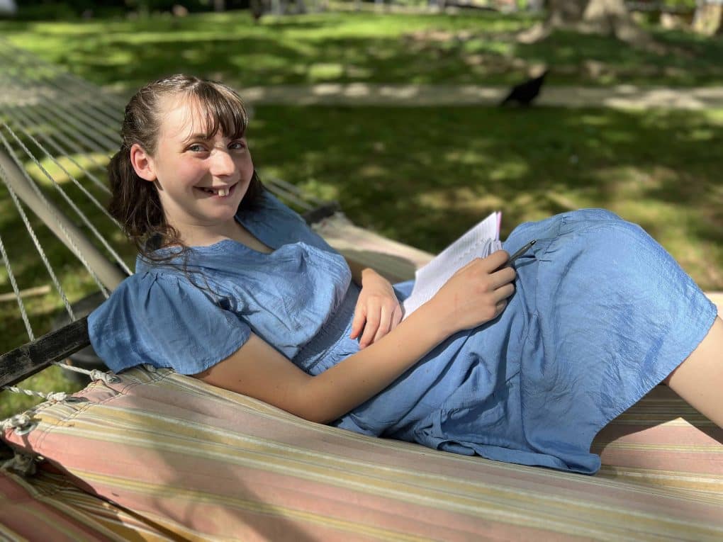 teen girl reading in hammock