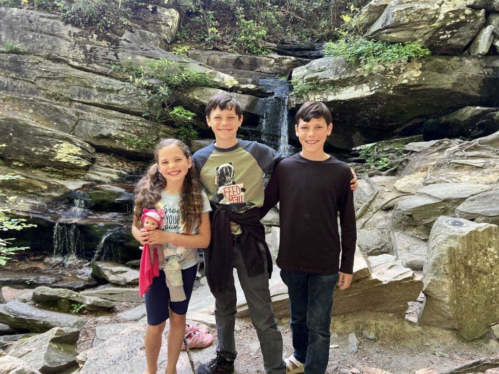 3 kids at a waterfall