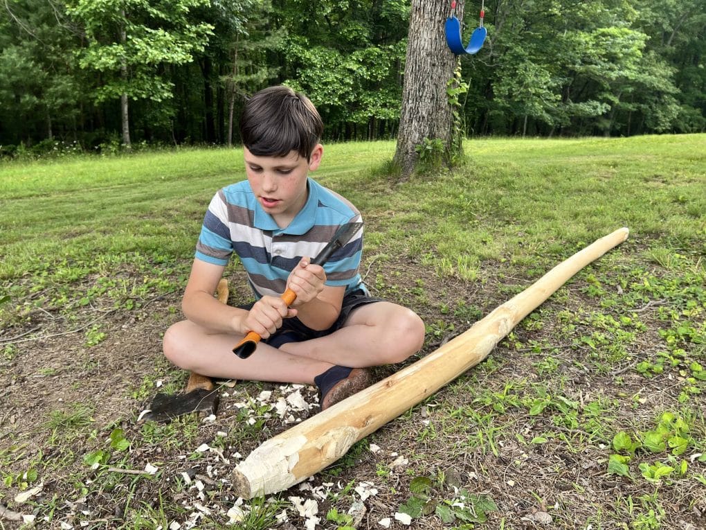 boy carves wood