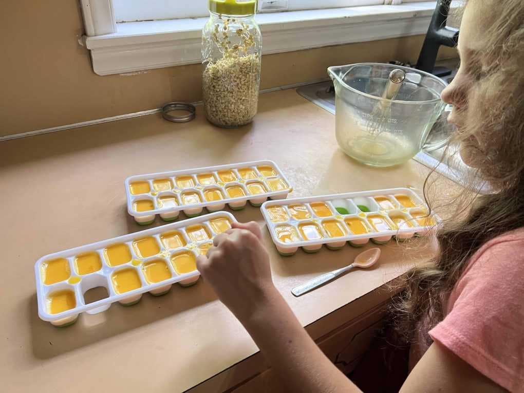 pouring eggs into ice cube molds