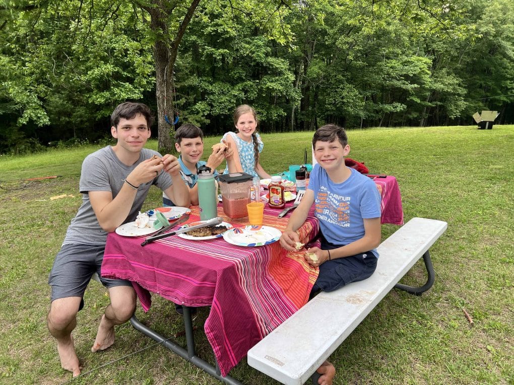 family eating at a picnic table
