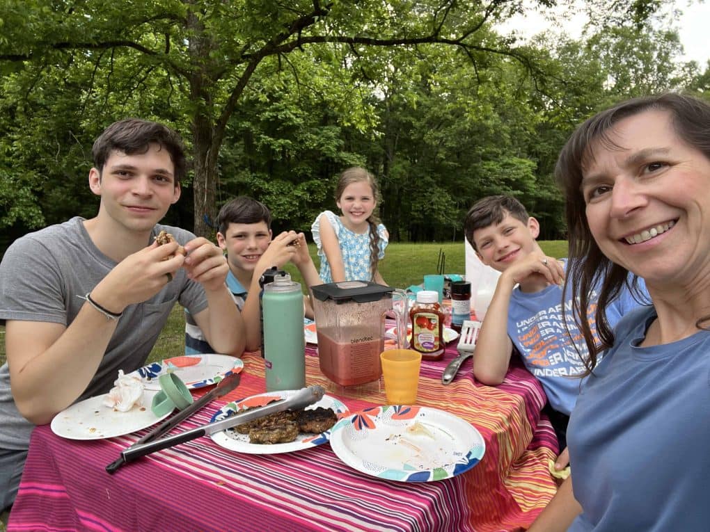 family eating at a picnic table