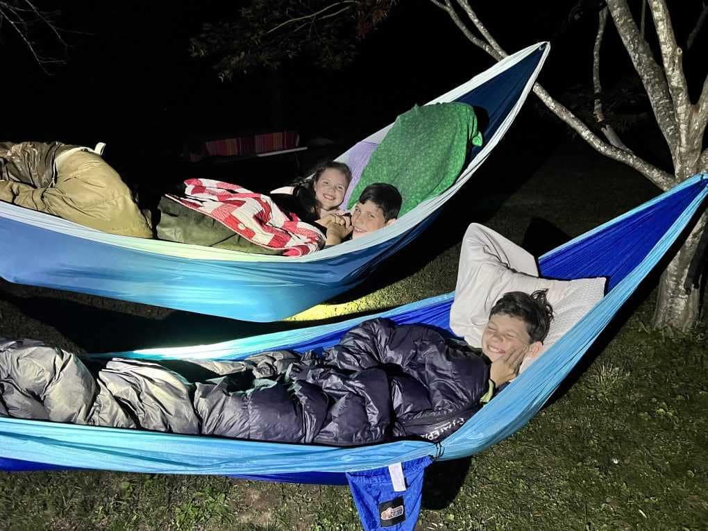 3 kids sleeping in hammocks
