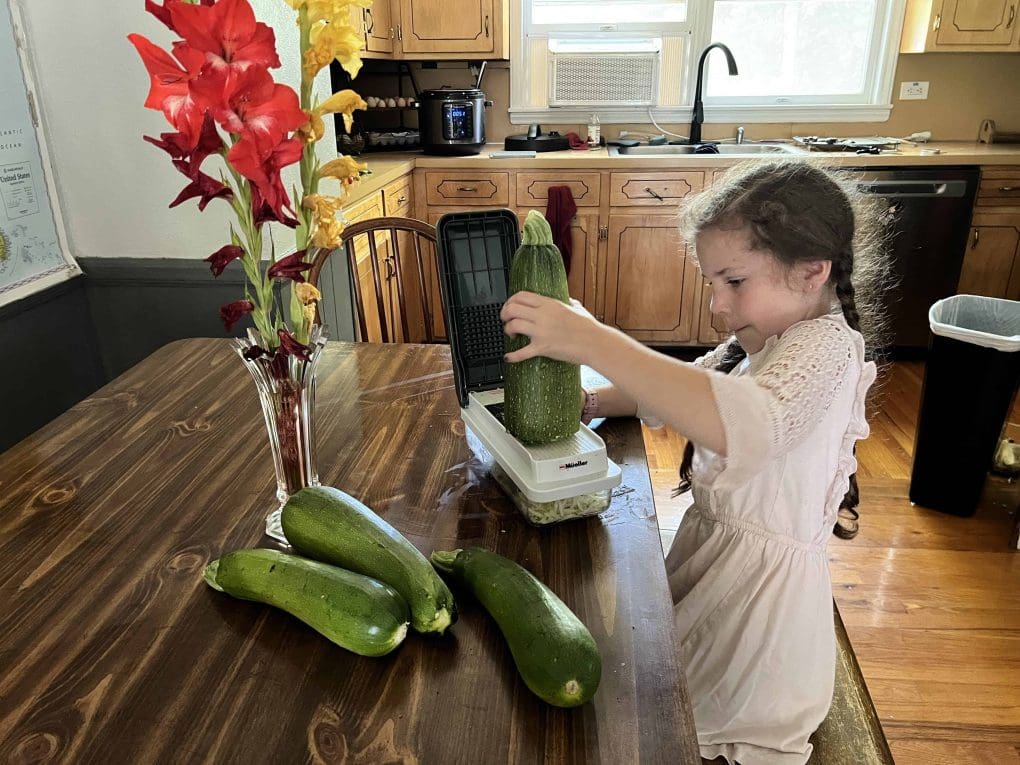 girl shredding cucumbers